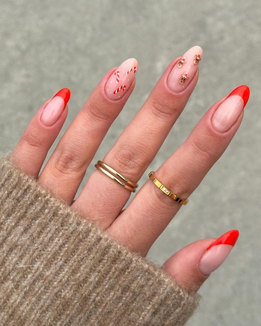 Red french tips with candy cane stripes and mini Rudolph accents