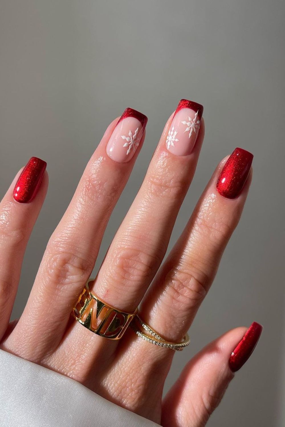 Red glitter french tip nails with snowflake accents