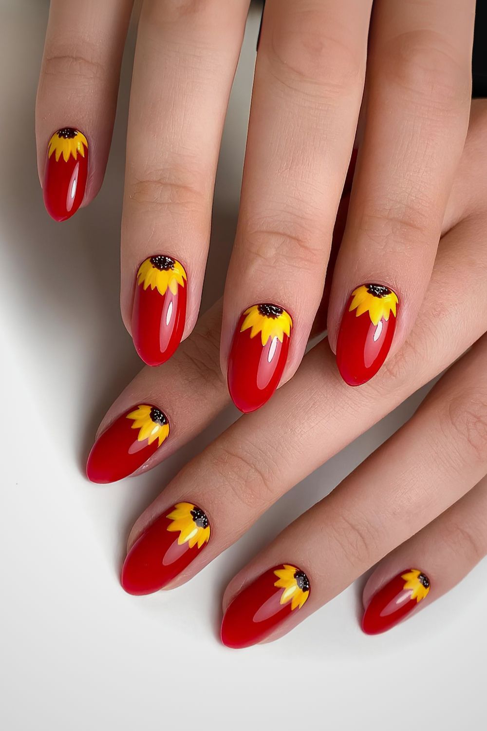 Red nails with sunflower accents