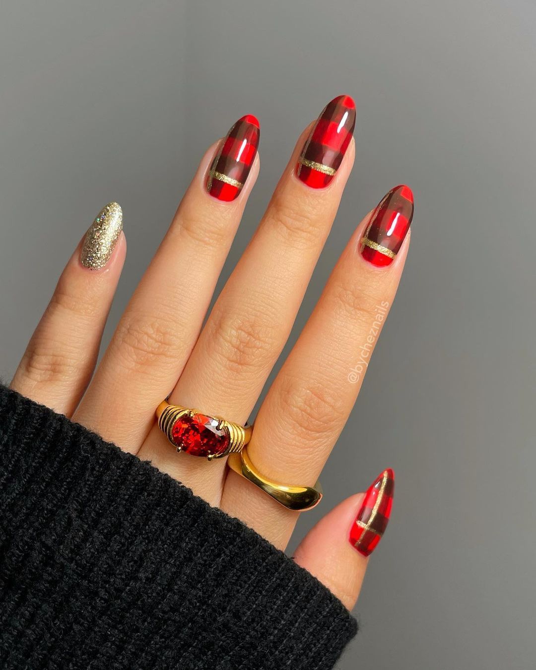 Red plaid nails with gold glitter accents