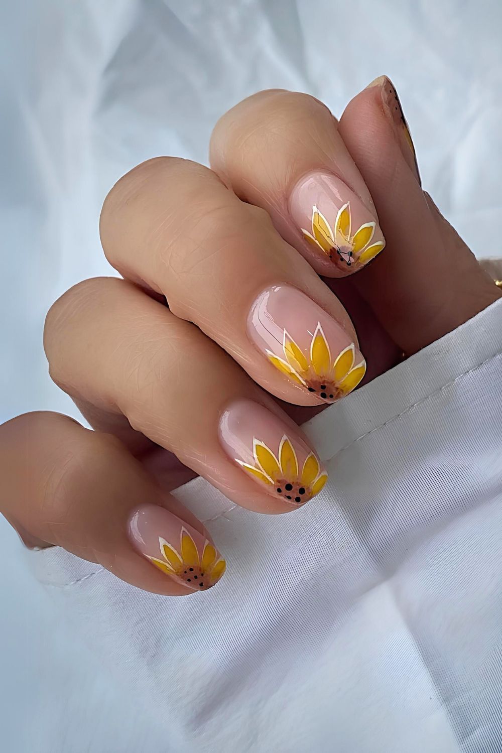 Sheer pink nails with chunky sunflower art