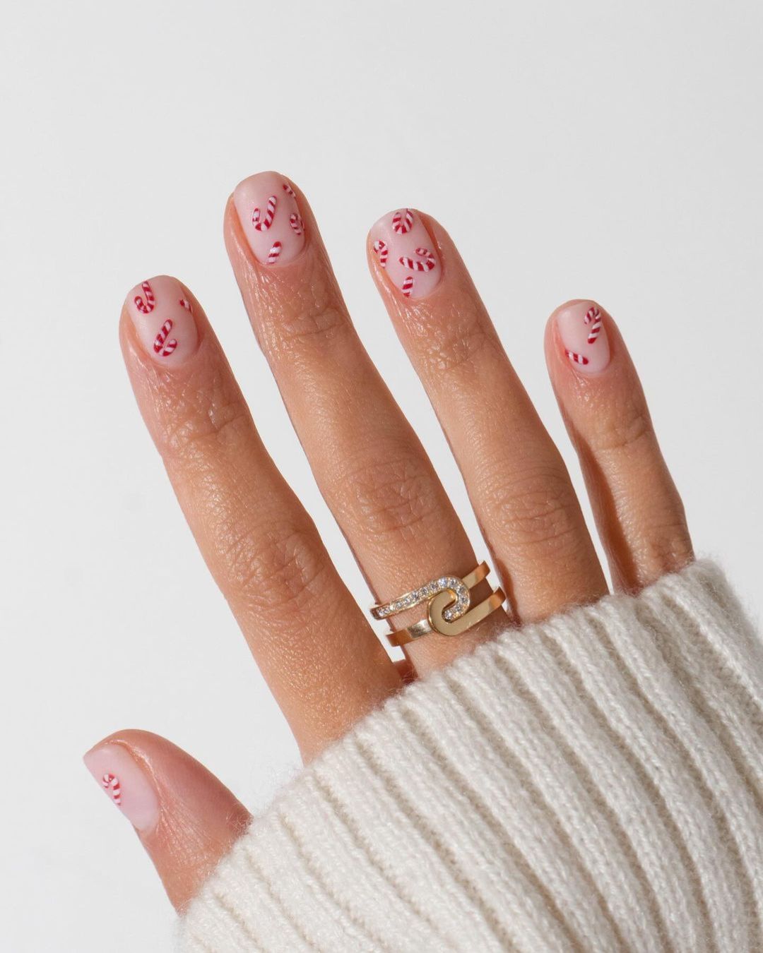 Short nude nails with tiny candy canes design