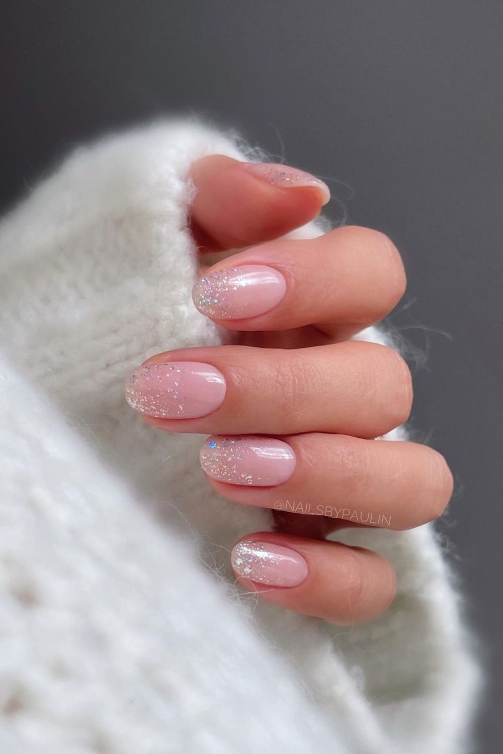 Soft pink nails with glitter ombre accent