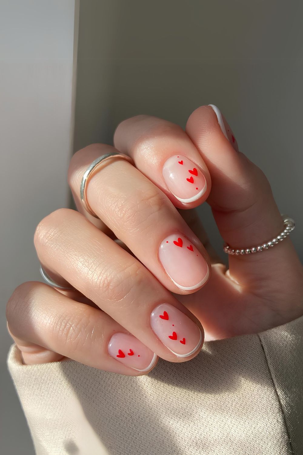 Thin French tip nails with heart accent