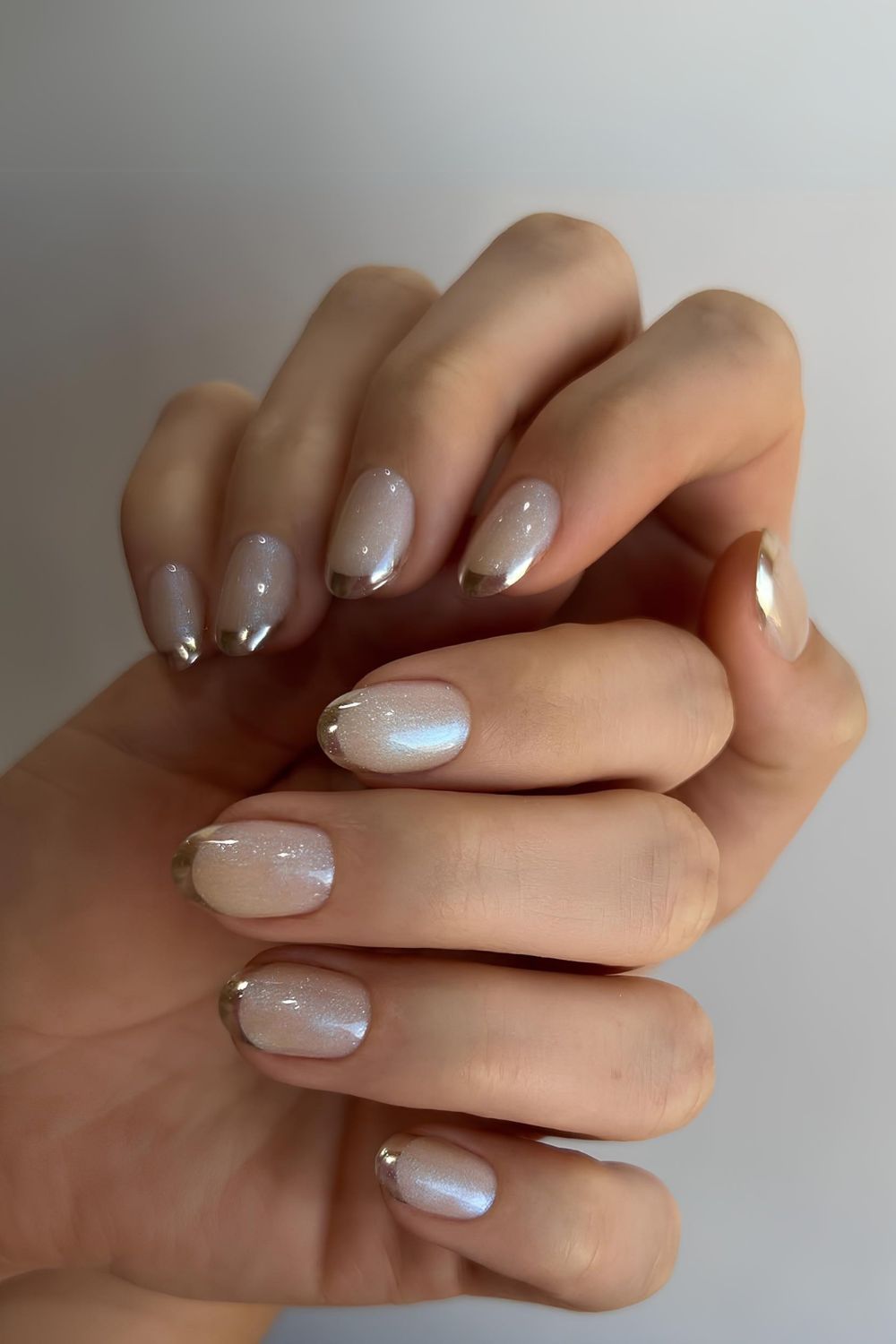 White chrome nails with gold tips