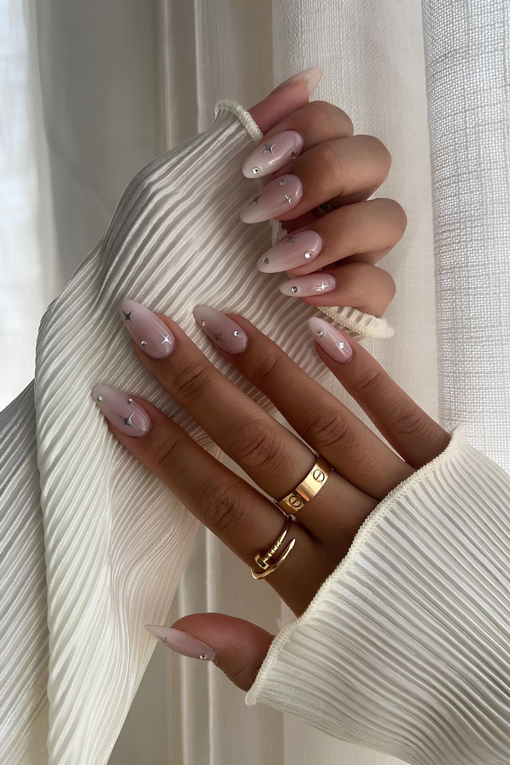 White ombre nails with chrome stars and rhinestones