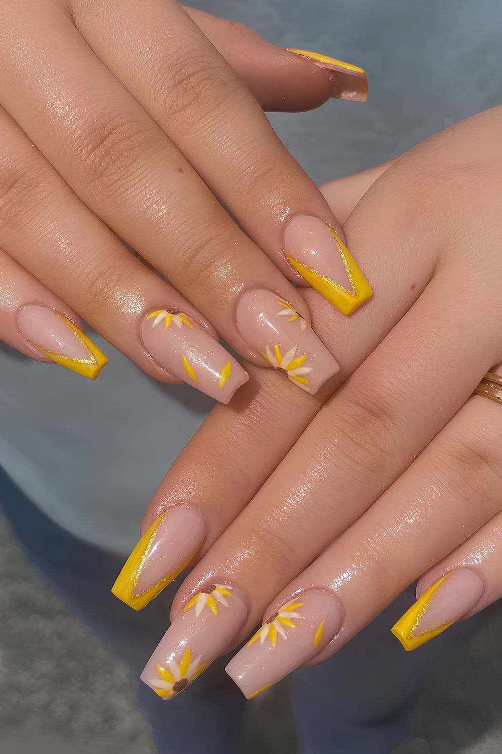 Yellow pointed French nails with sunflower