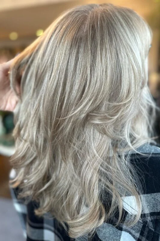 Blonde hair with highlights and lowlights for seamless gray blending.