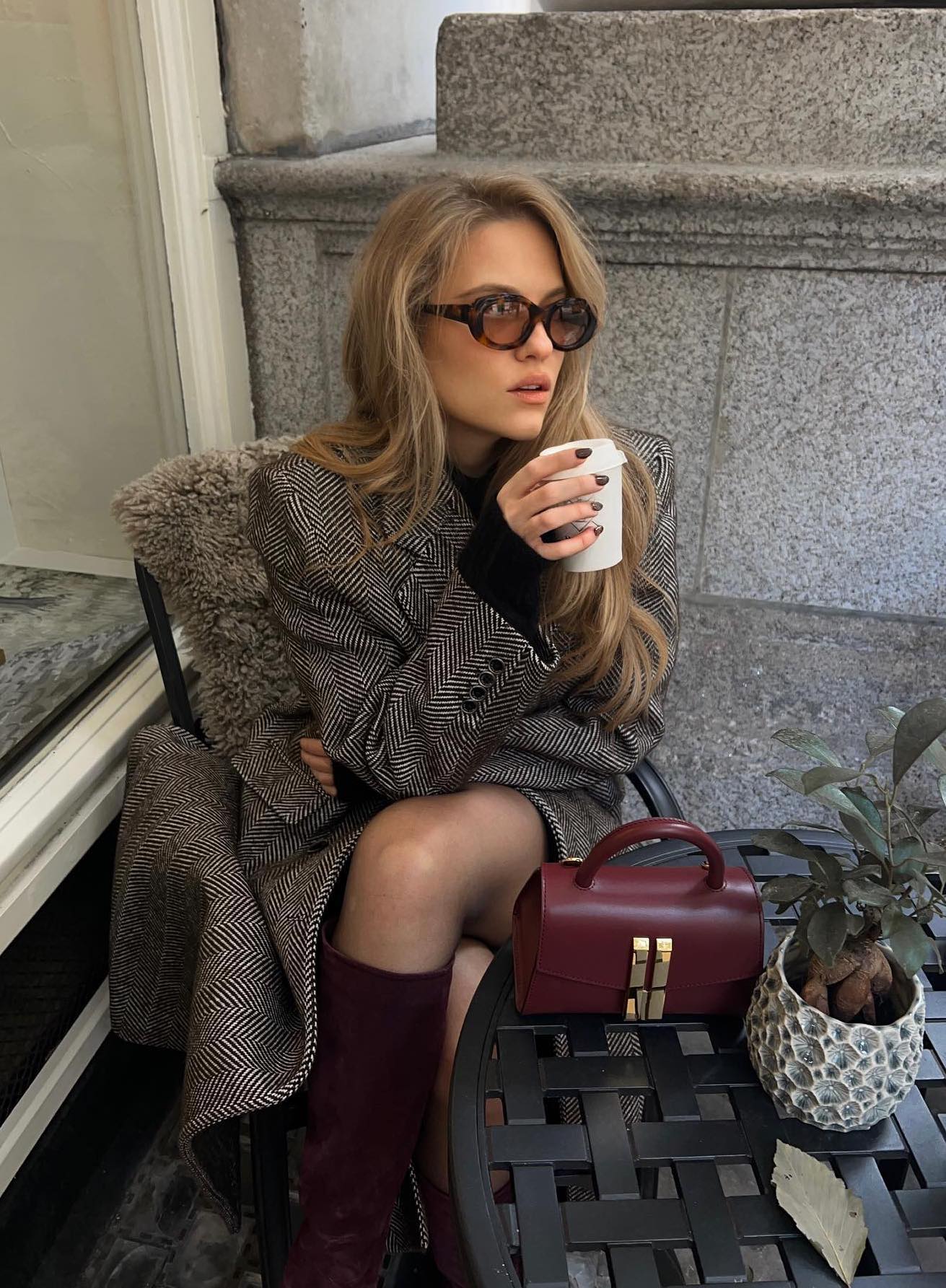 Burgundy boots and bag with a grey coat