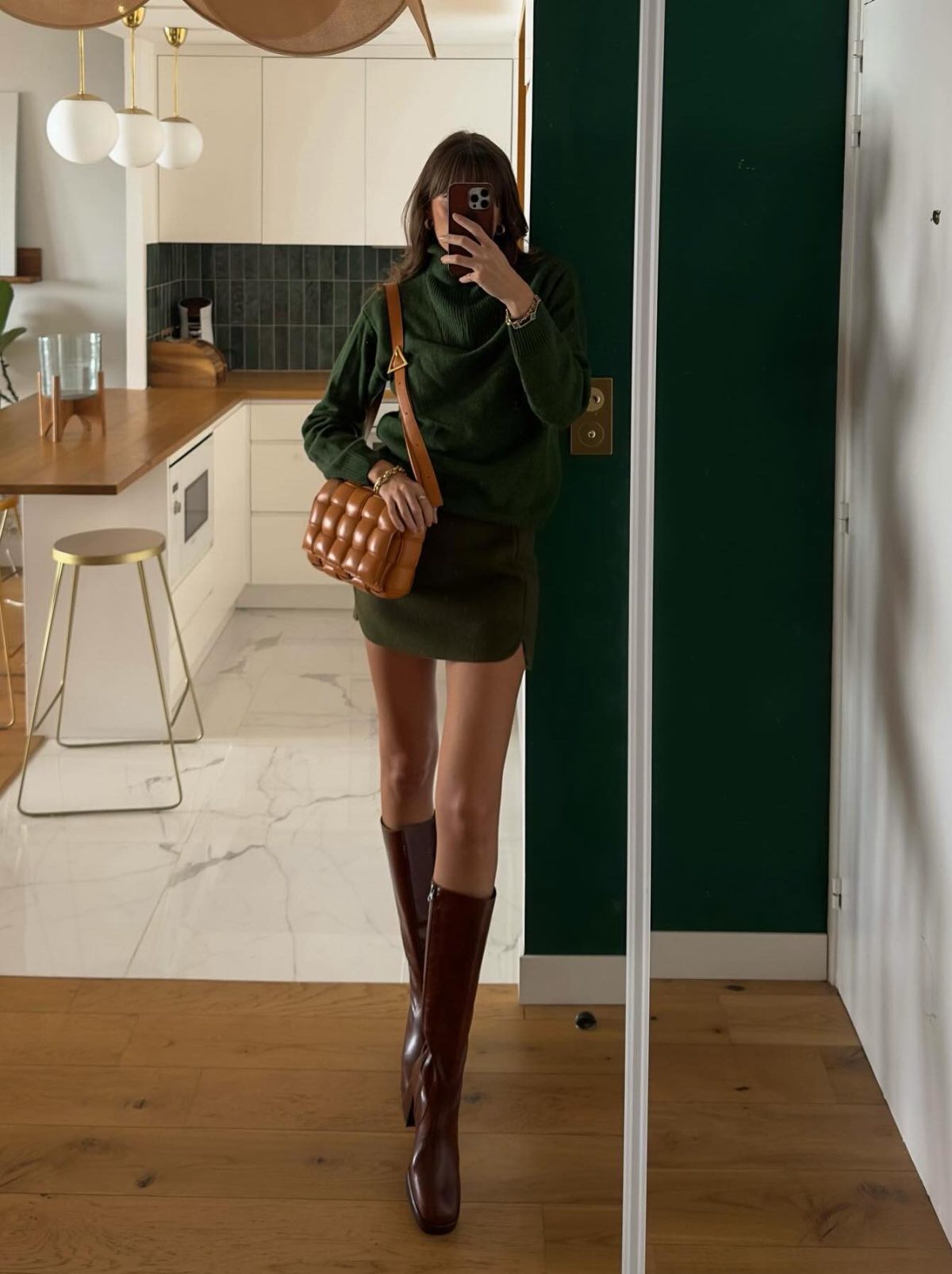 Burgundy boots outfit with a green sweater and skirt