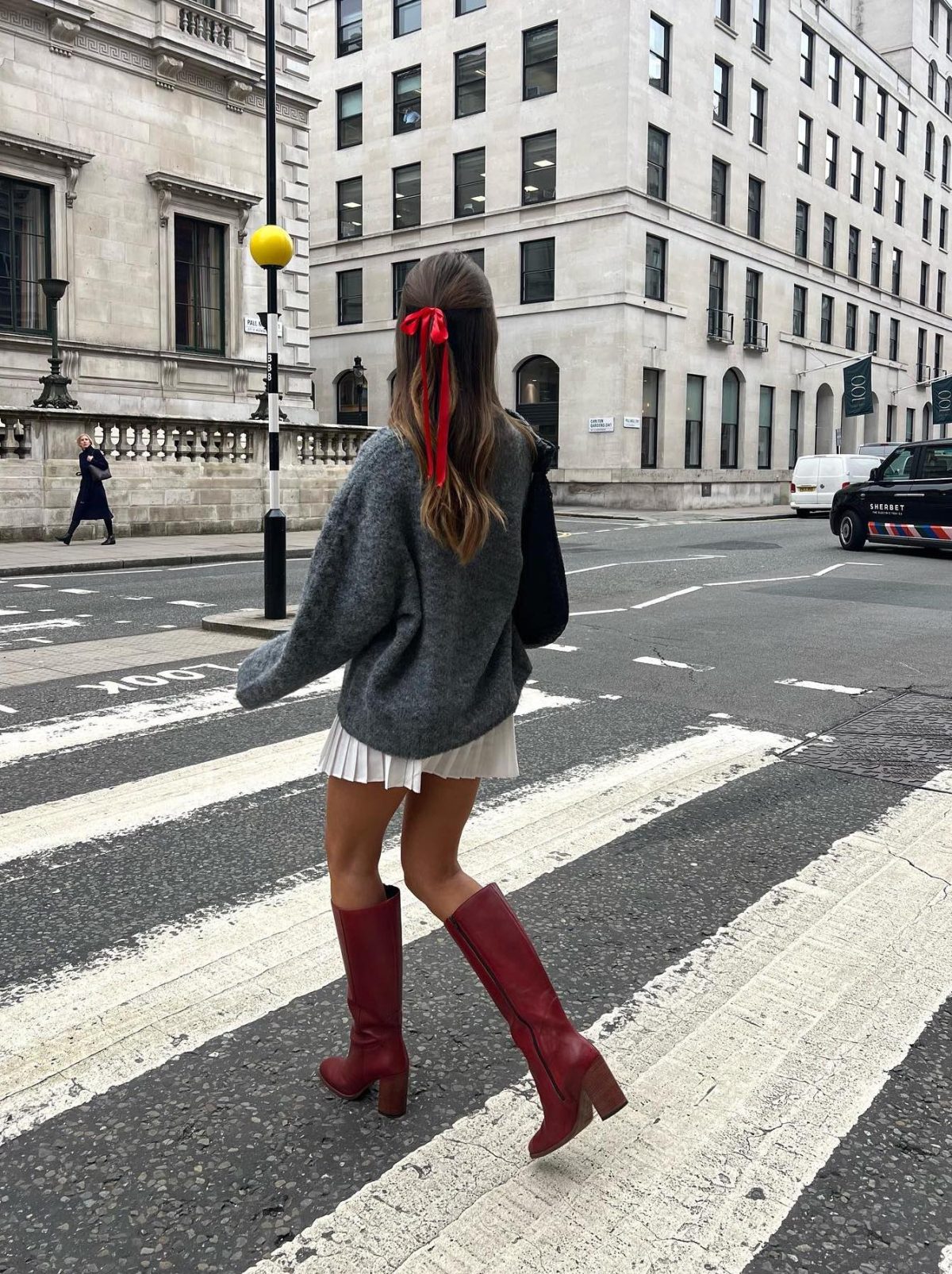 Burgundy boots with grey sweater and a white mini skirt