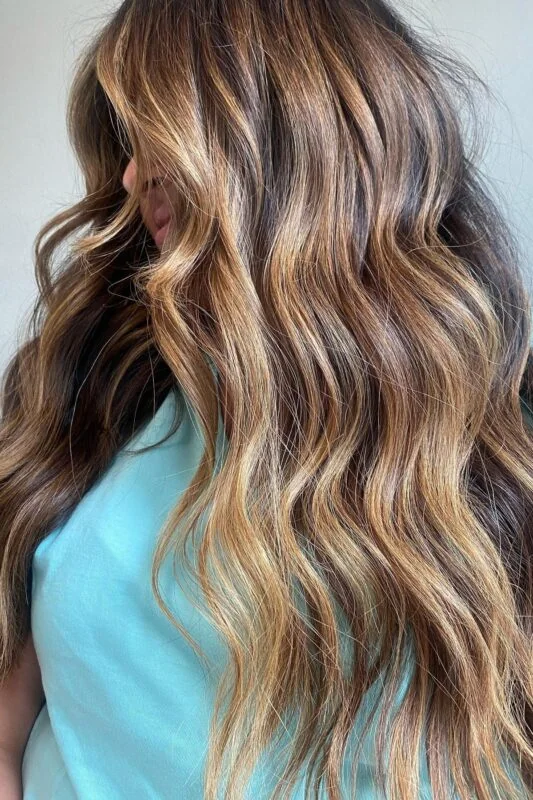 Woman with a caramel bronze hair color.