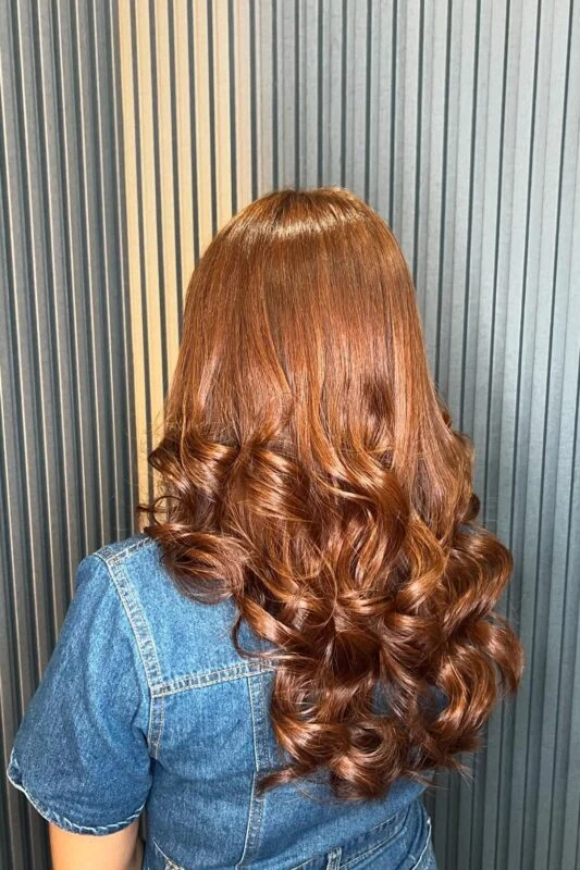 A woman with a caramel brown hair color.