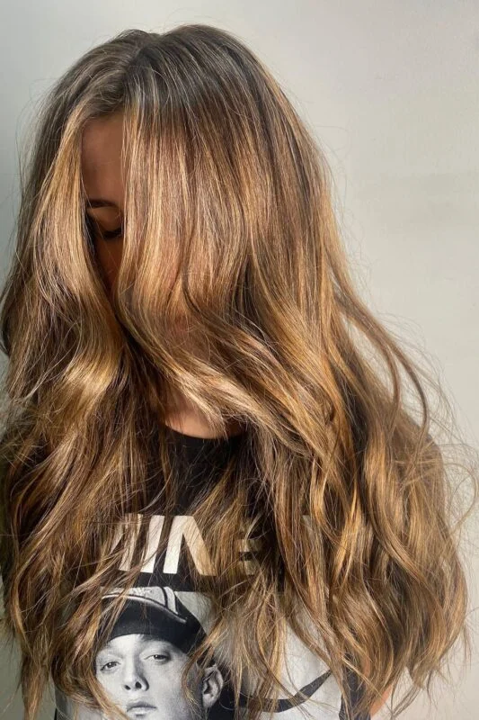 Woman with a caramel golden brown hair color.