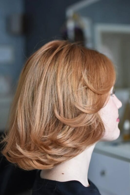 Woman with a chin-length butterfly bob haircut.