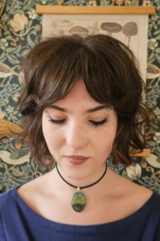 Woman with a chin-length feathered bob haircut.