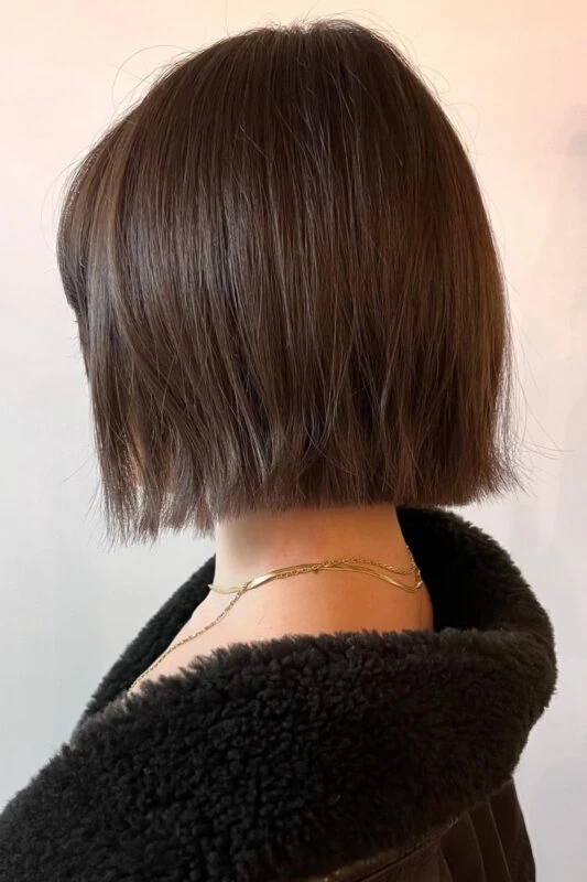 Woman with a chin-length French bob haircut.