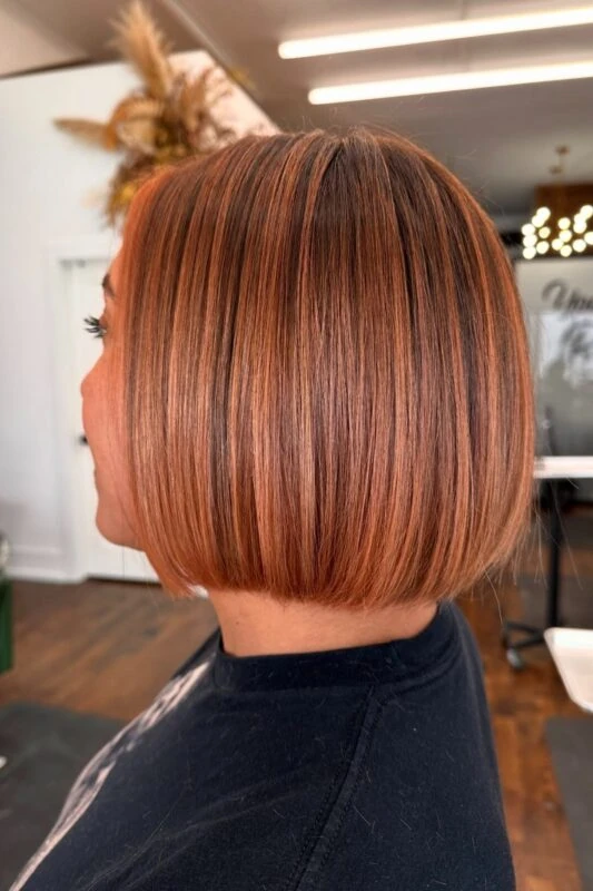 Woman with a chin-length streaky blunt bob haircut.