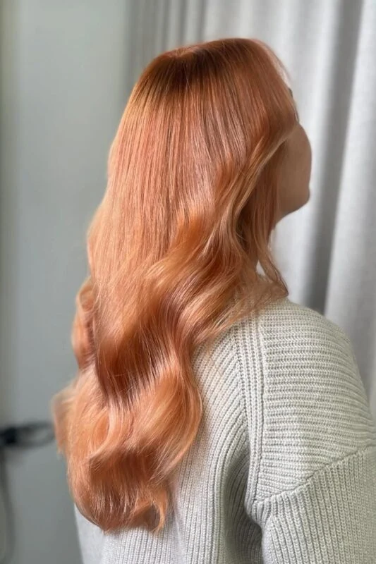 Woman with a copper peach hair color.