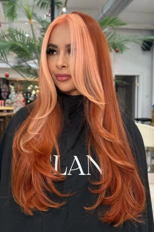 Woman with a coral peach hair color.