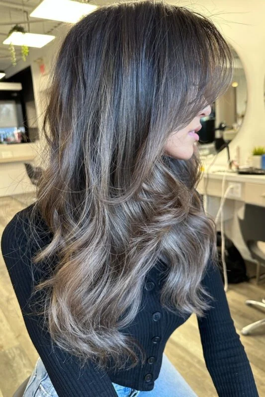 Woman with dark ash brown hair.