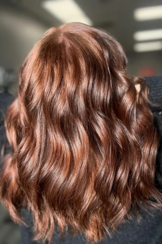 Woman with a golden auburn hair color.