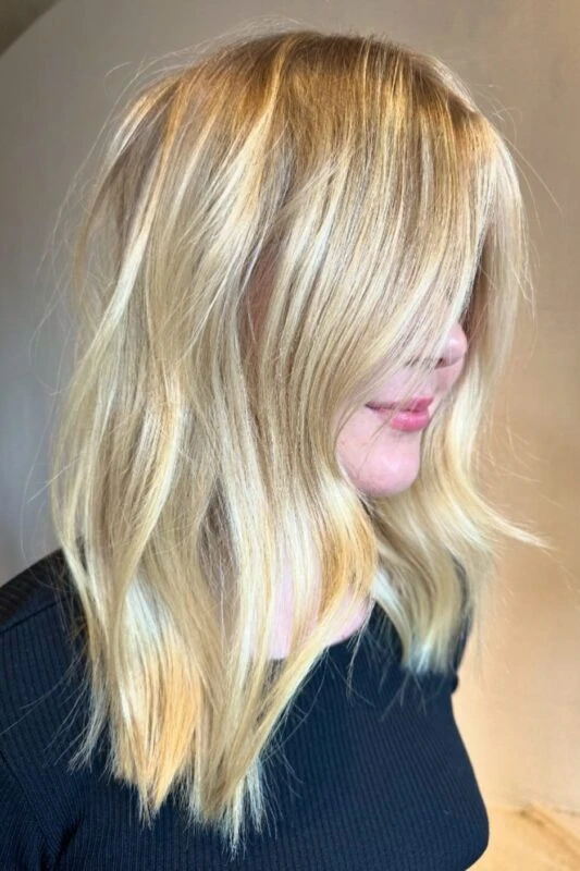 Woman with a golden blonde balayage.