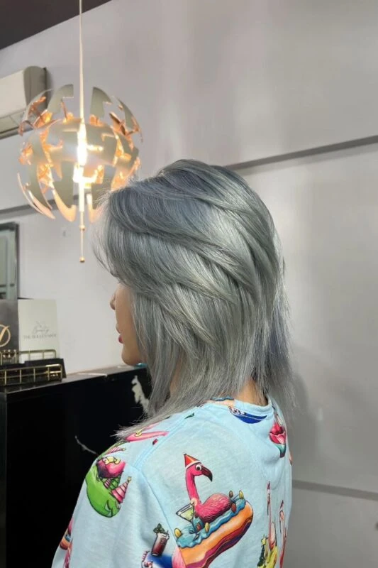 Woman with a gunmetal hair color.