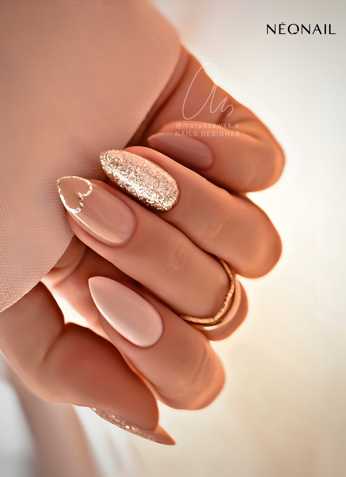 Neutral and gold nails with a heart