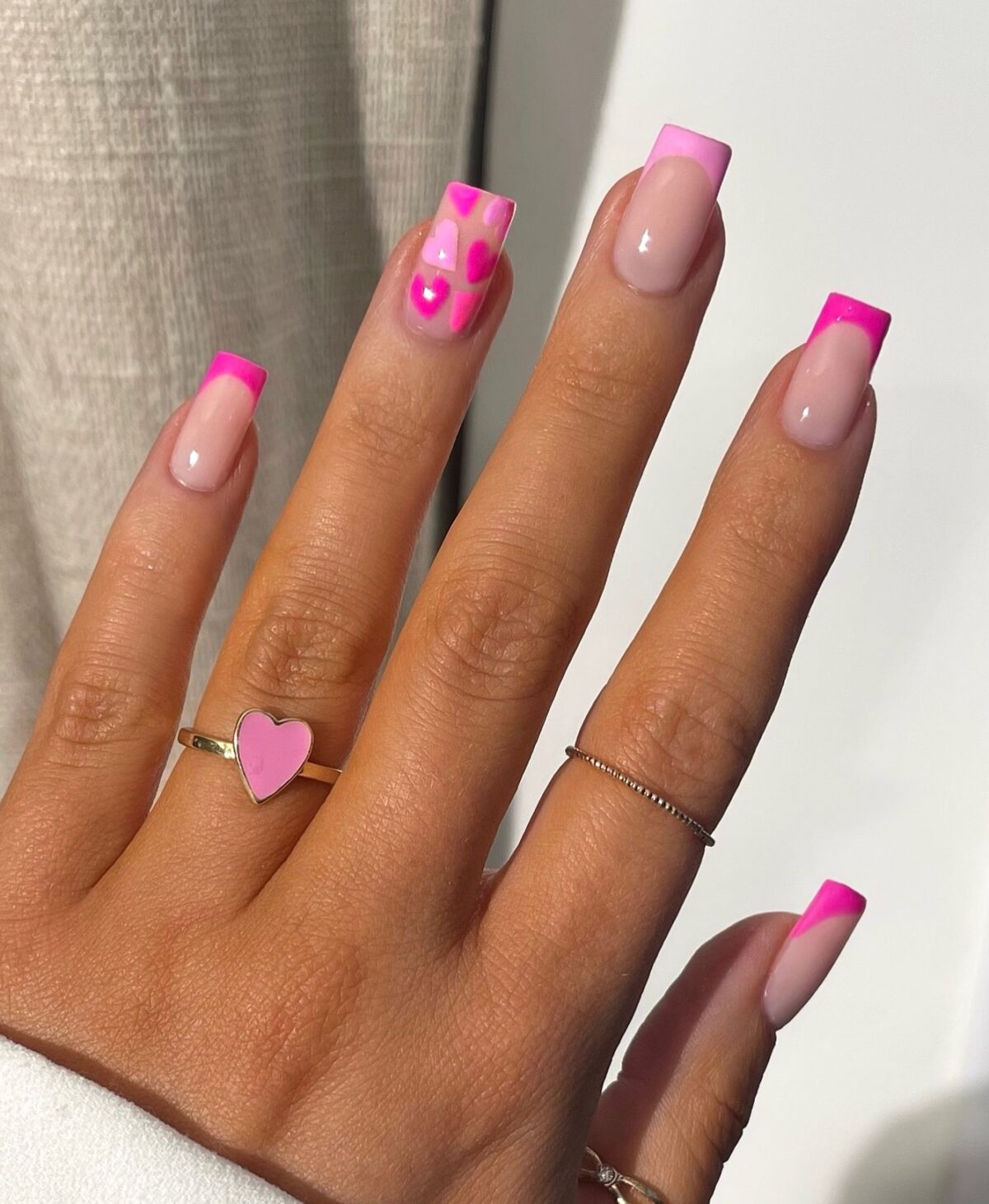 Hot pink French tip nails with hearts