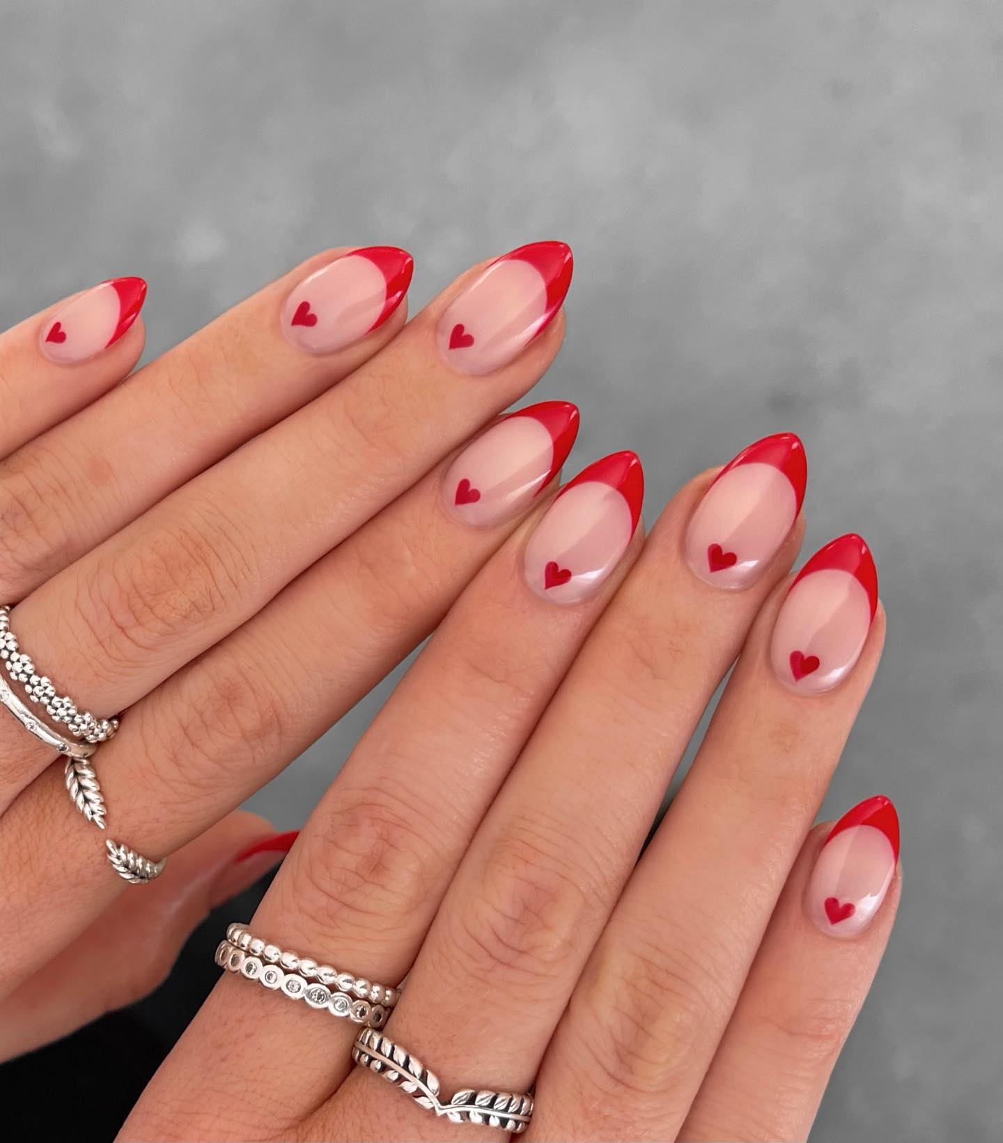 Red French tip nails with hearts