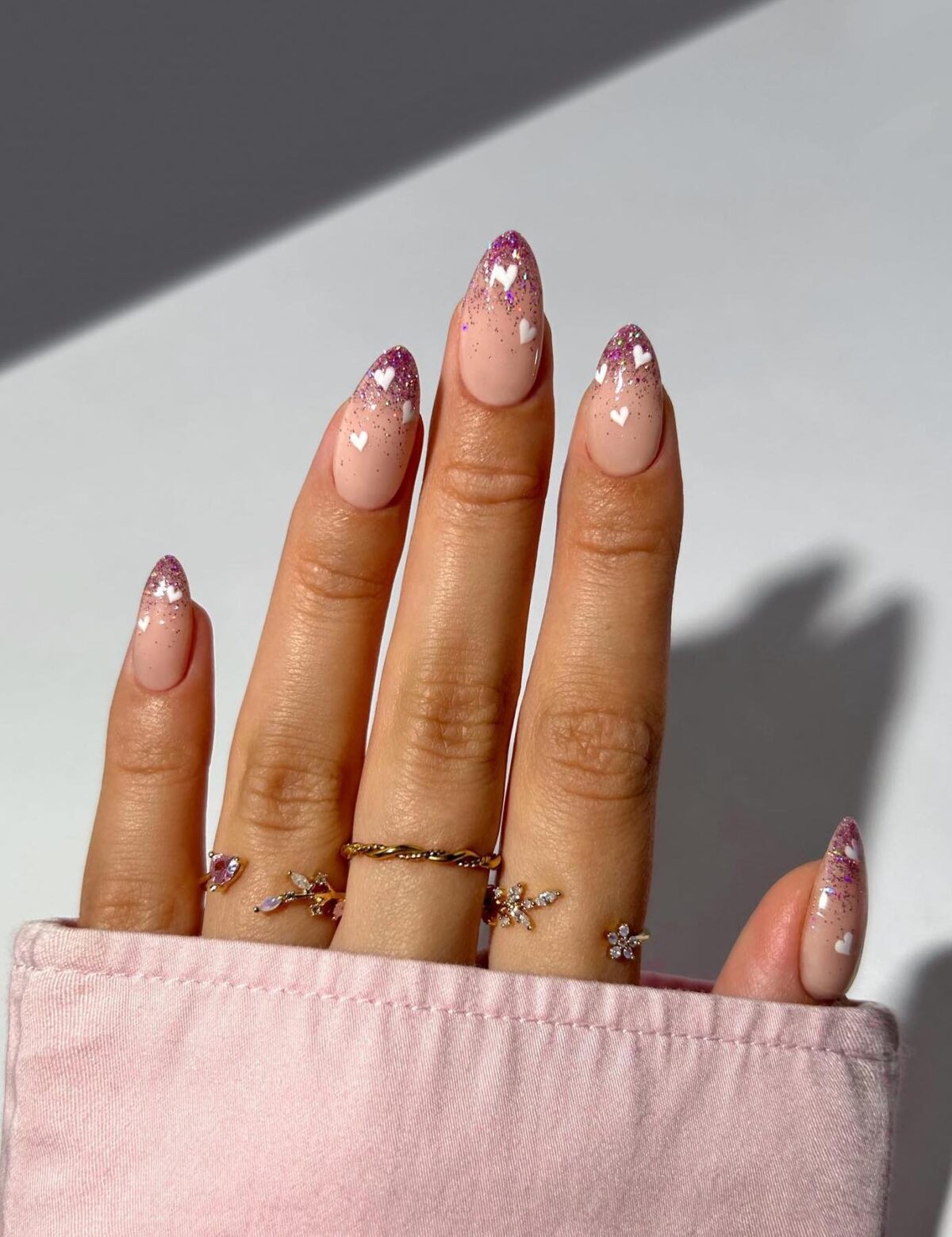 Pink glitter French tip nails with white hearts