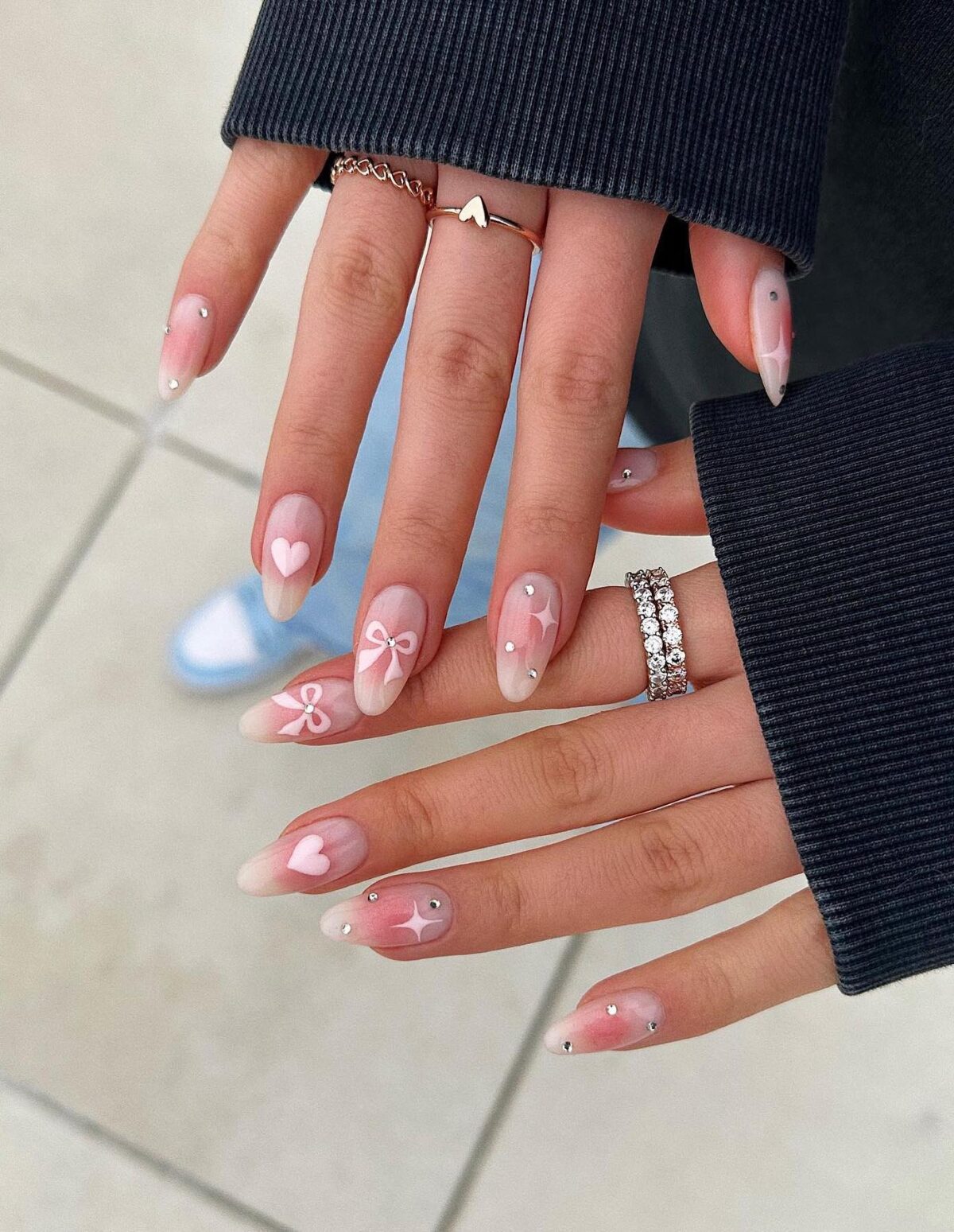 Cute white and pink coquette nails with hearts and ribbons