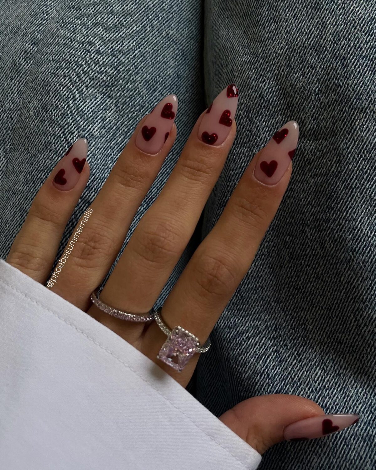 Cute red heart nails on a clear nail bed