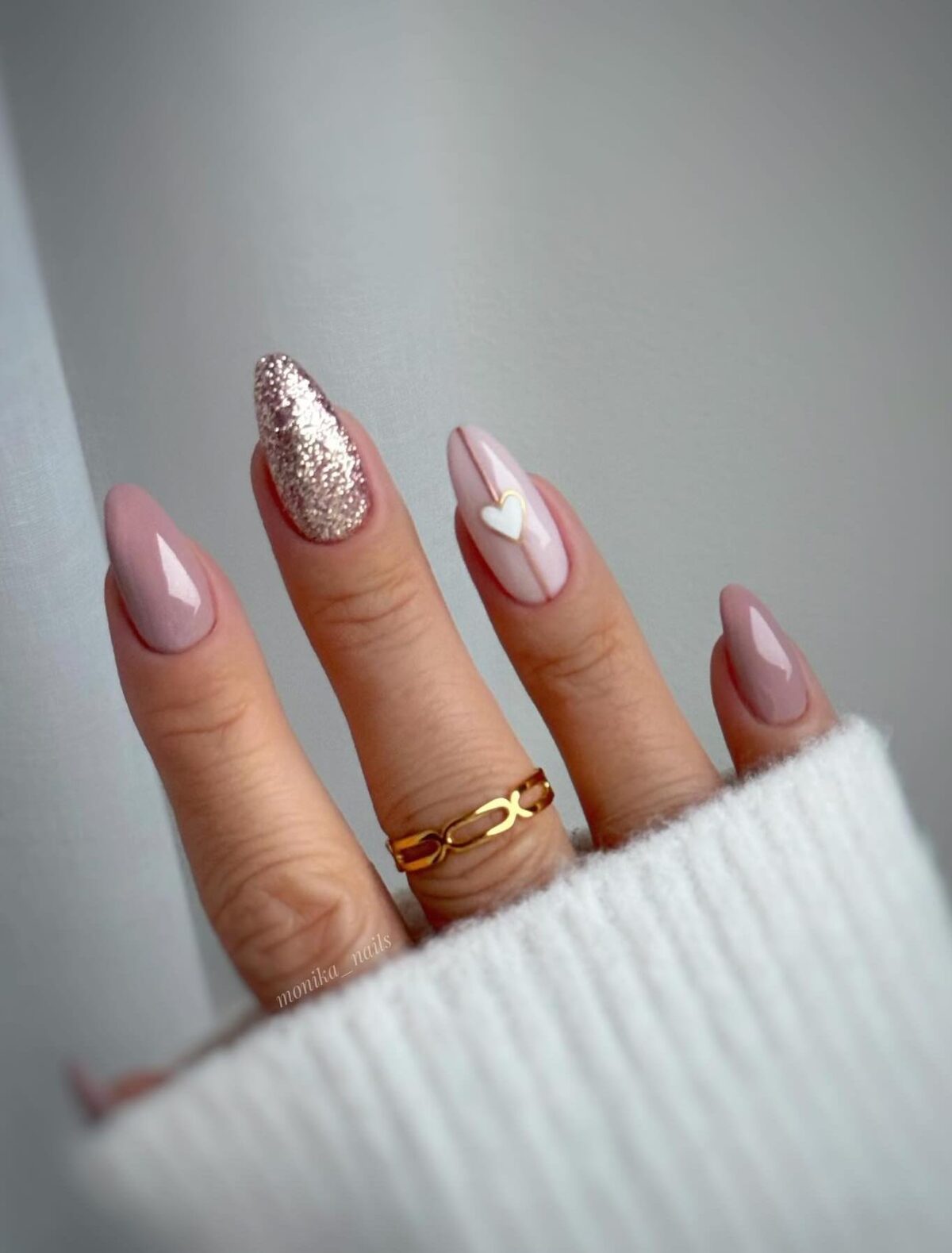 Neutral nails with gold glitter and a heart