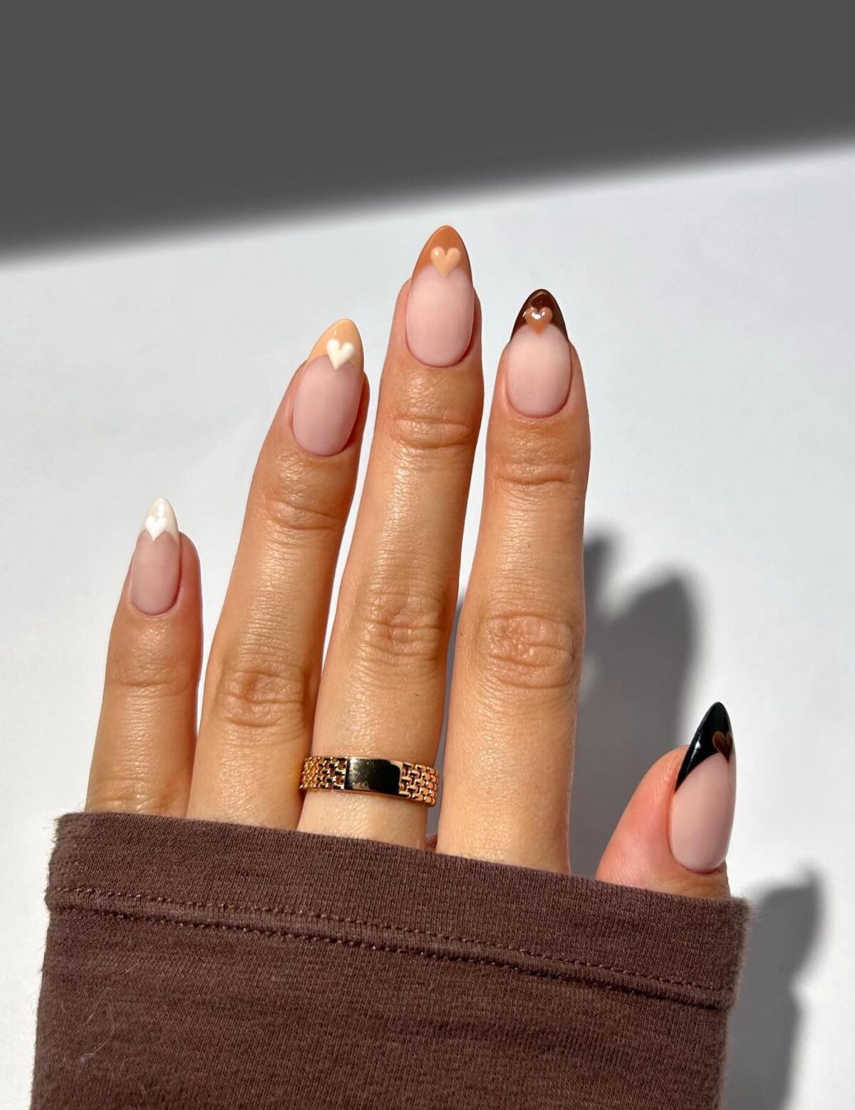 Neutral and brown French tip nails with hearts