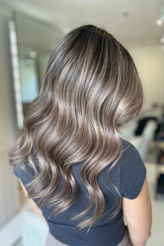 A woman with a light ash brown hair color.