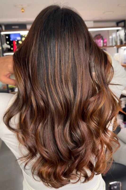 A woman with a light cinnamon brown hair color.