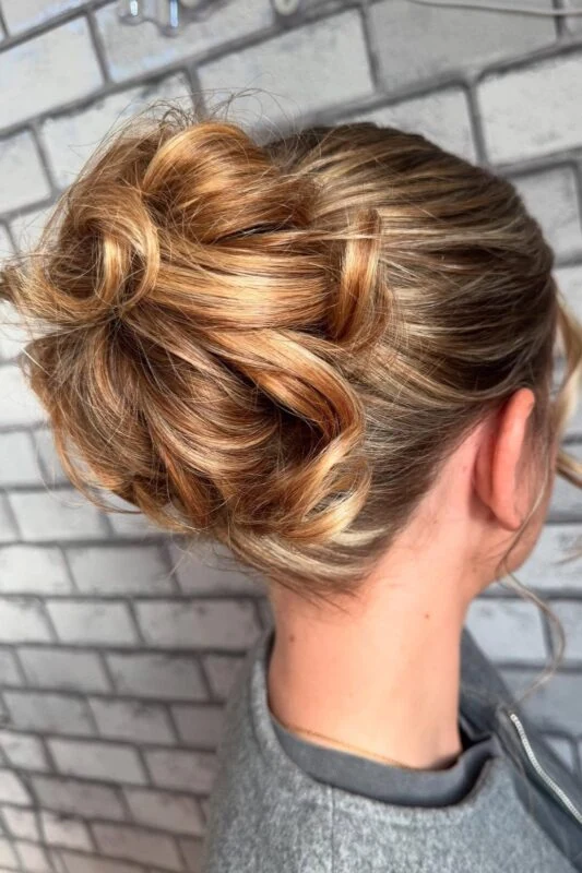 Woman with a twisted messy bun updo.