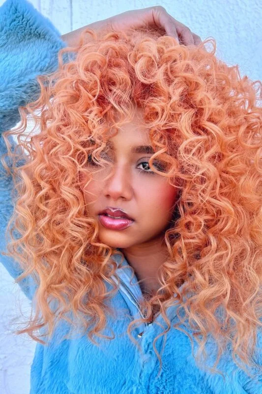 Woman with an orange peach hair color.