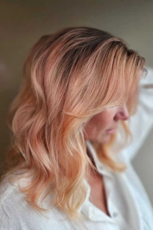 Woman with a peach hair ombre hairstyle.