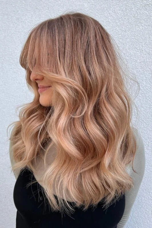 Woman with a peachy blonde hair color.