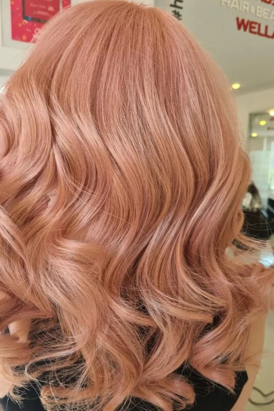 Woman with a rose gold peach hair color.