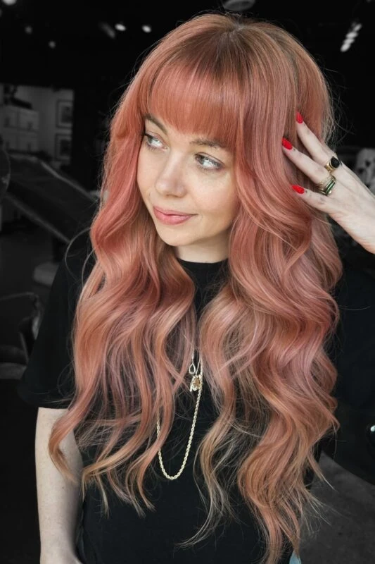 Woman with a rose gold peach hair color.