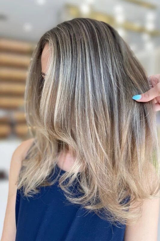 Sandy blonde highlights subtly hiding gray hair for brunettes.