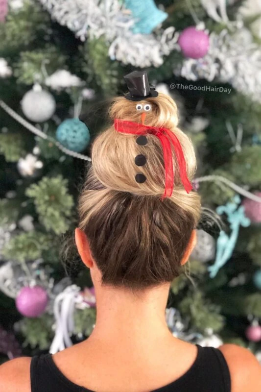 Woman with a snowman-themed bun updo.