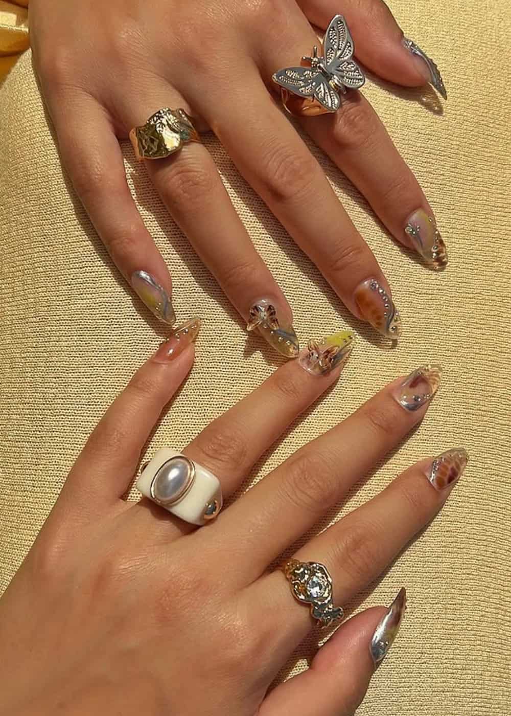 long almond nails with charms and jewels