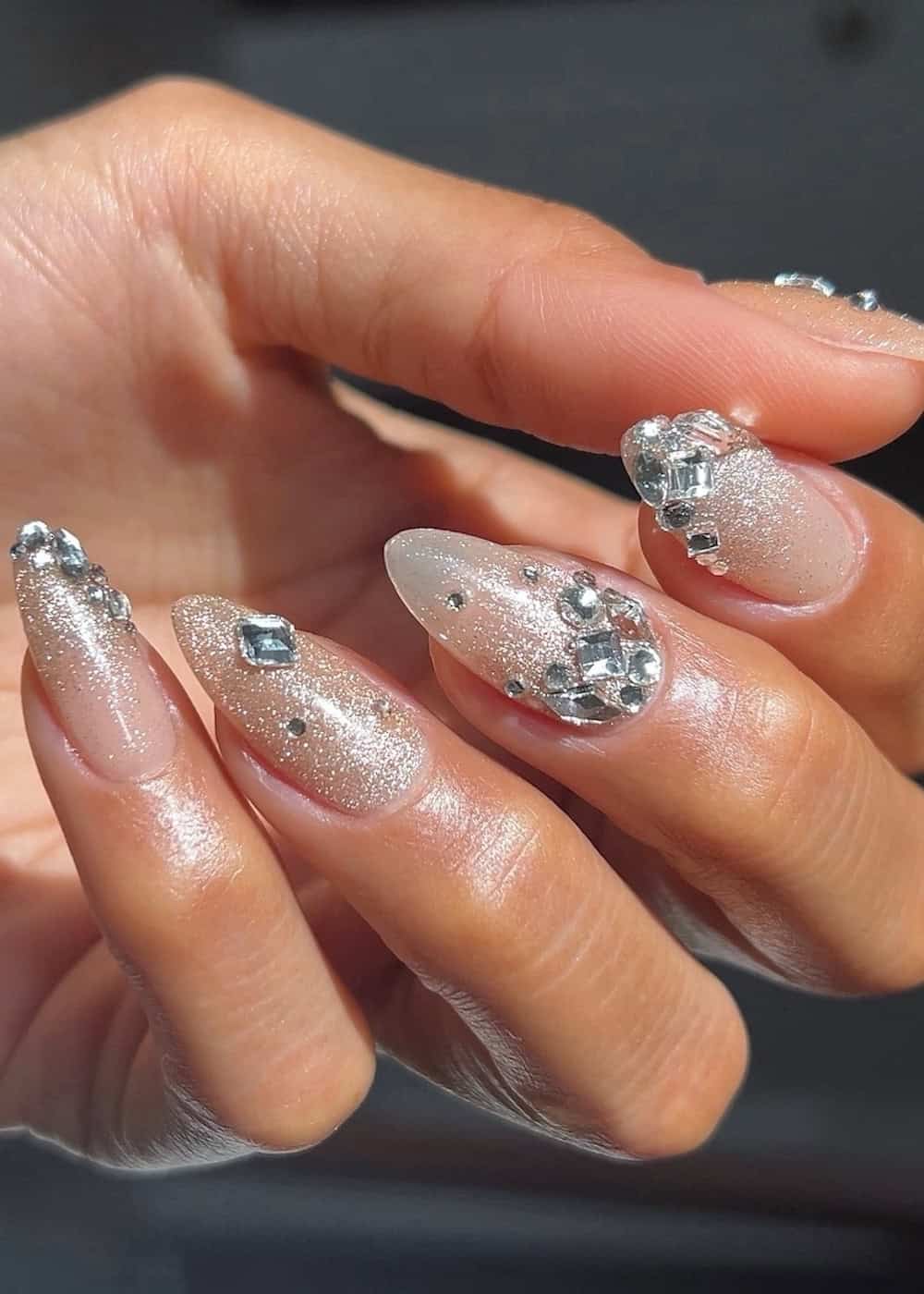 long shimmering almond nails with gems