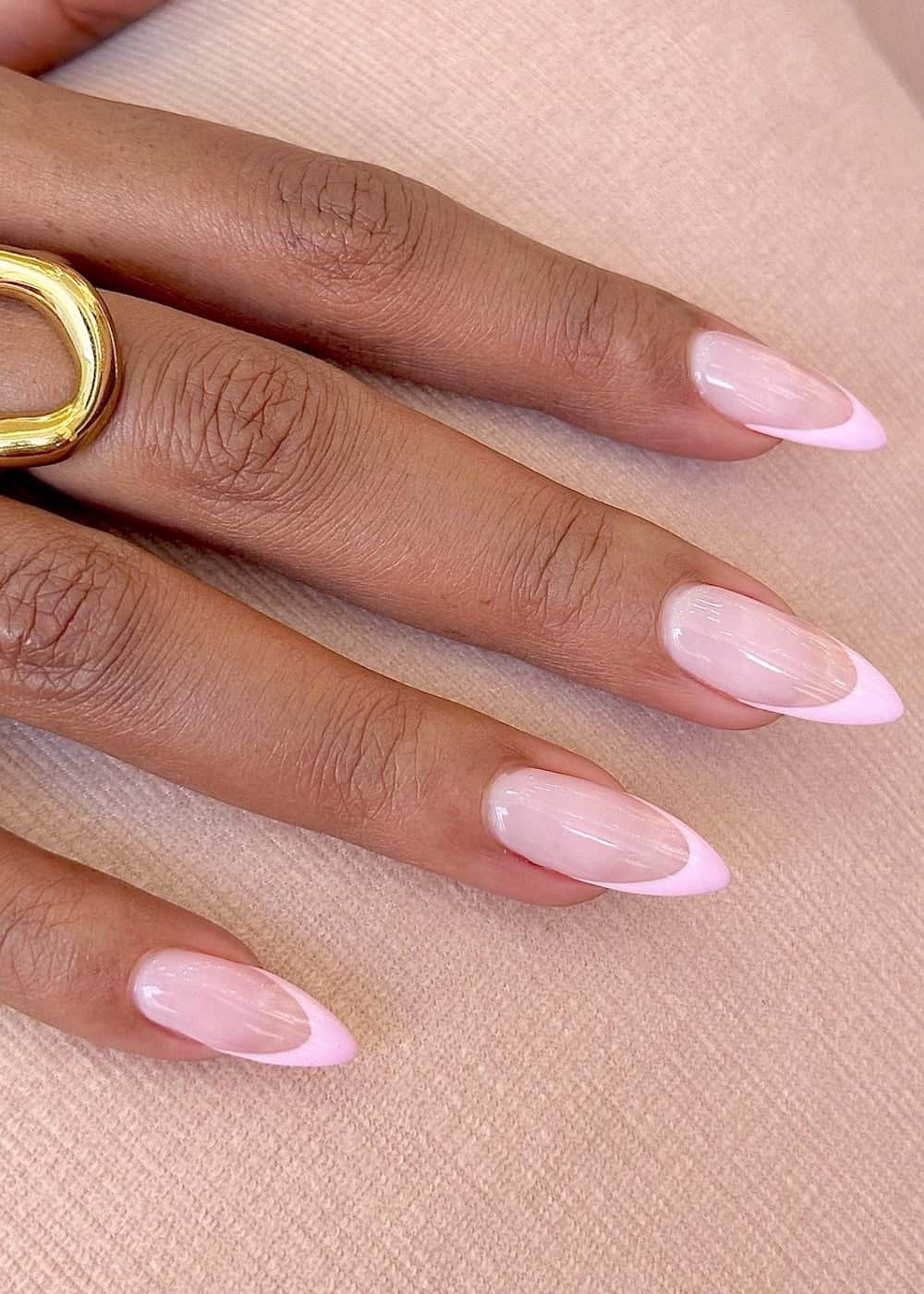 long pointy almond nails with soft pink polish and pink tips