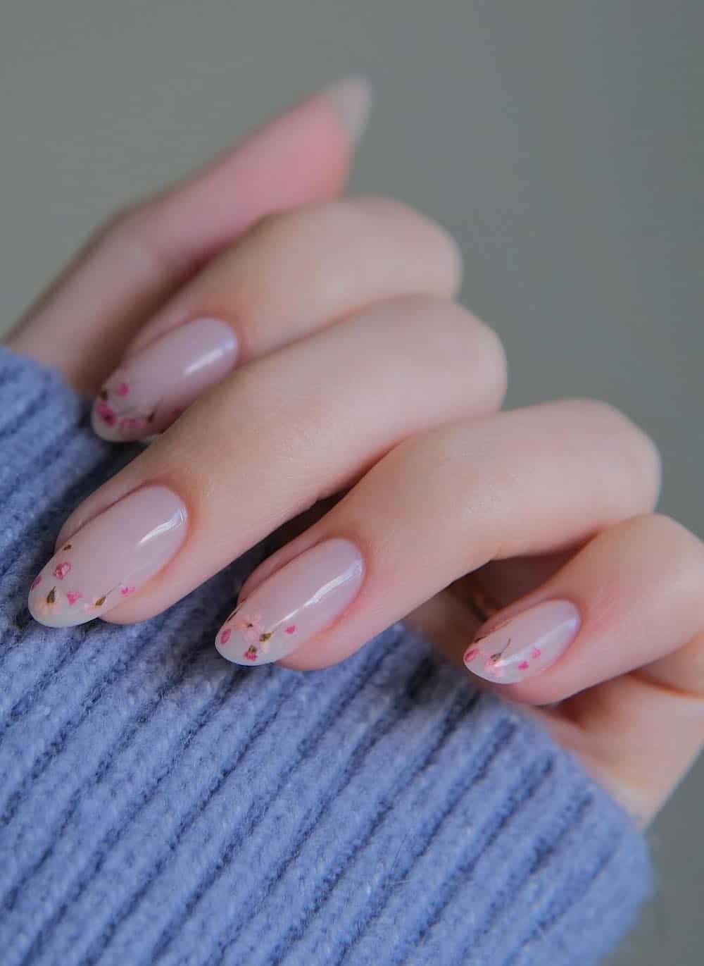 short nude almond nails with dainty dried flower tips